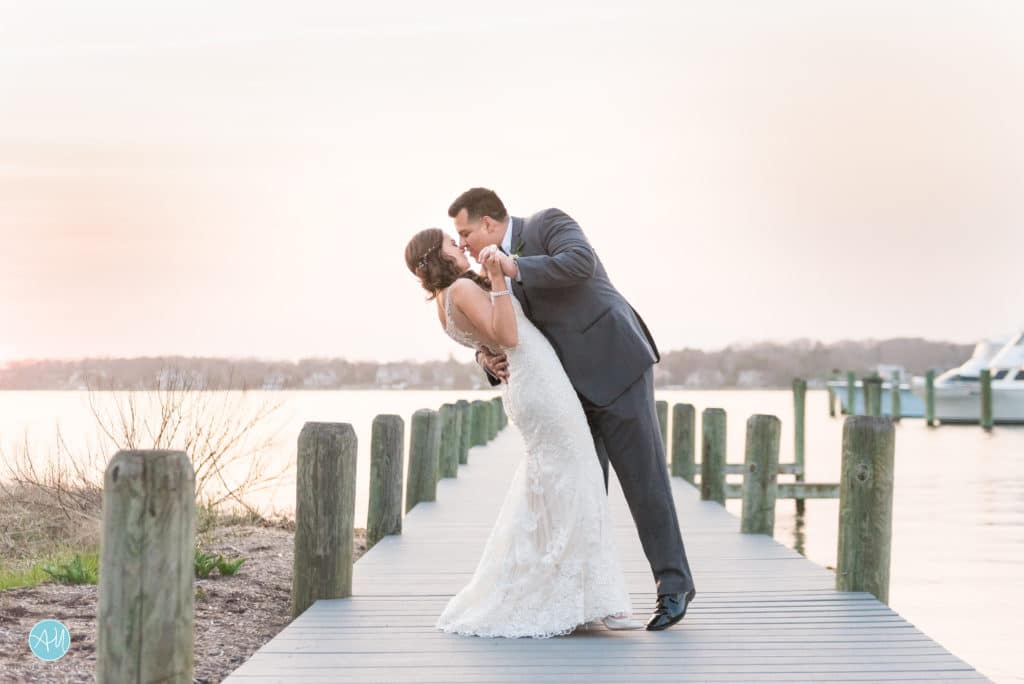 Groom dips bride on the dock at Clarks Landing Yacht Club Point Pleasant