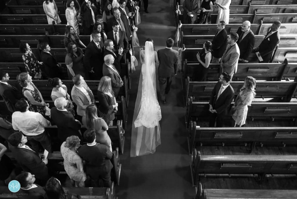 Bride walking down the aisle from above. Black and white photo.