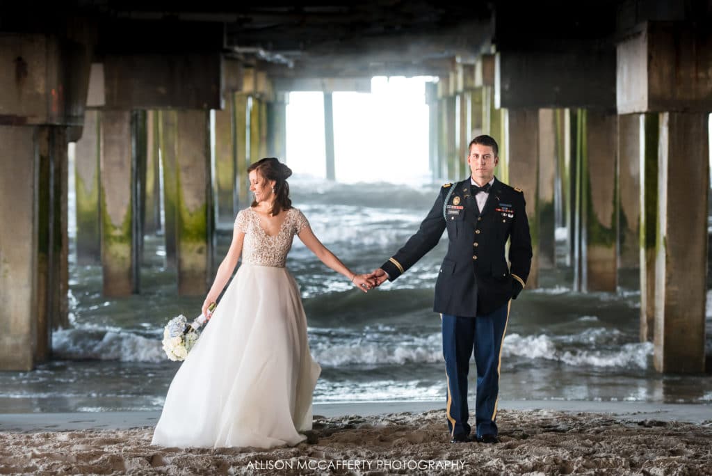 Bride and groom under the pier in Atlantic City