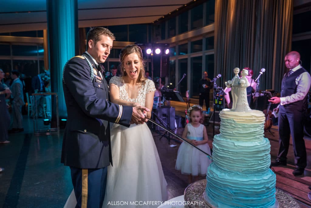 cutting wedding cake with saber