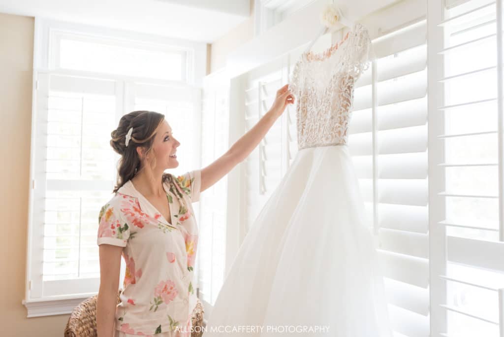 Bride admiring her wedding gown