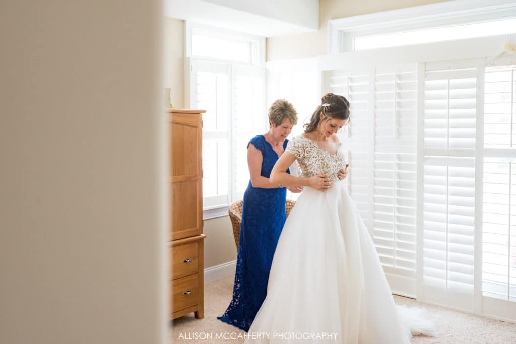 Mother of the bride dressing her daughter