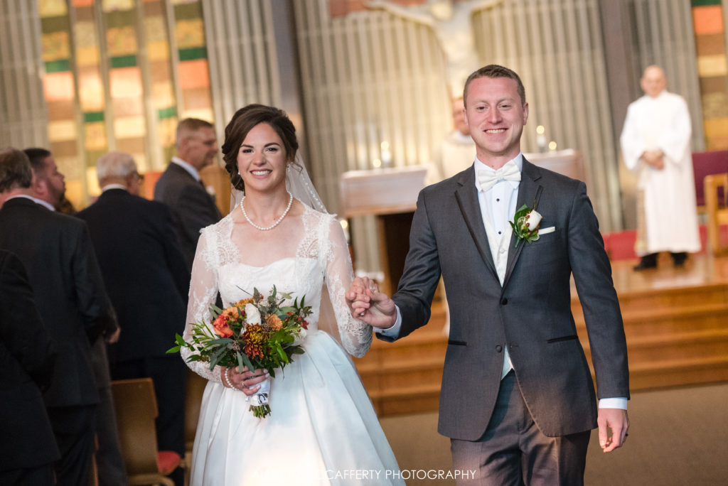 Bride and groom exiting church after wedding ceremony