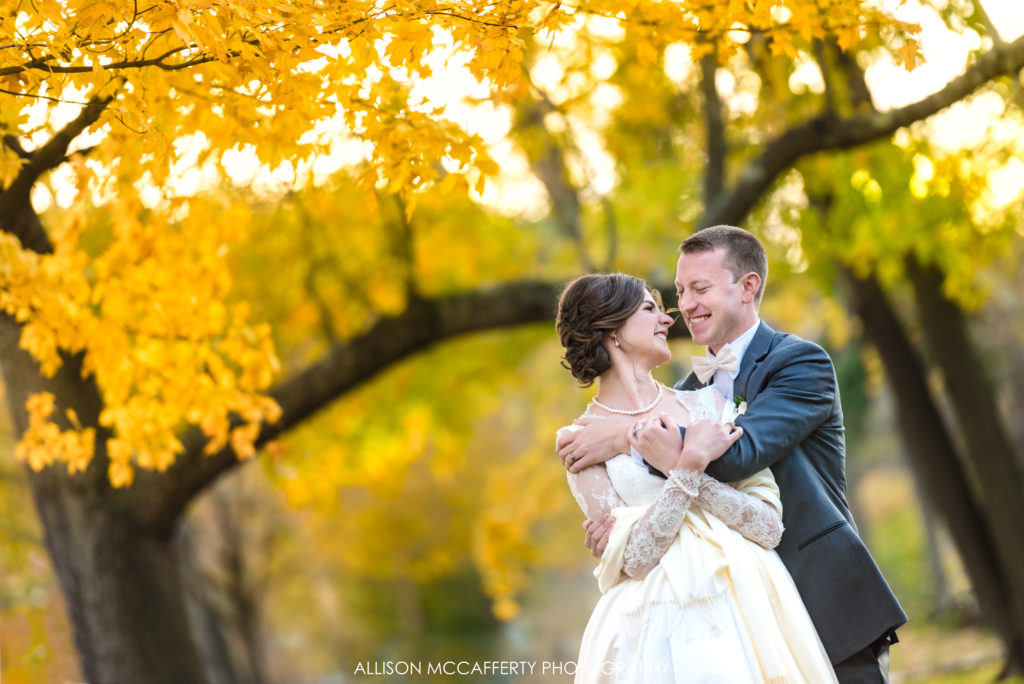 Bride and groom under yellow tree in Collingwood NJ