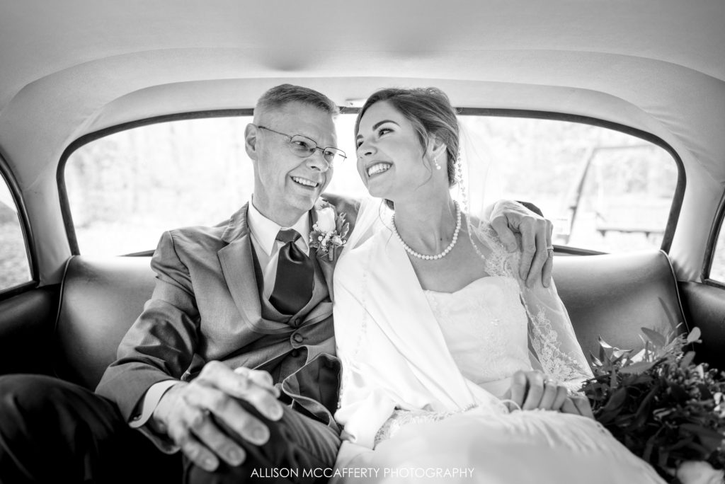 Bride and her Dad in his old taxi before going to wedding ceremony