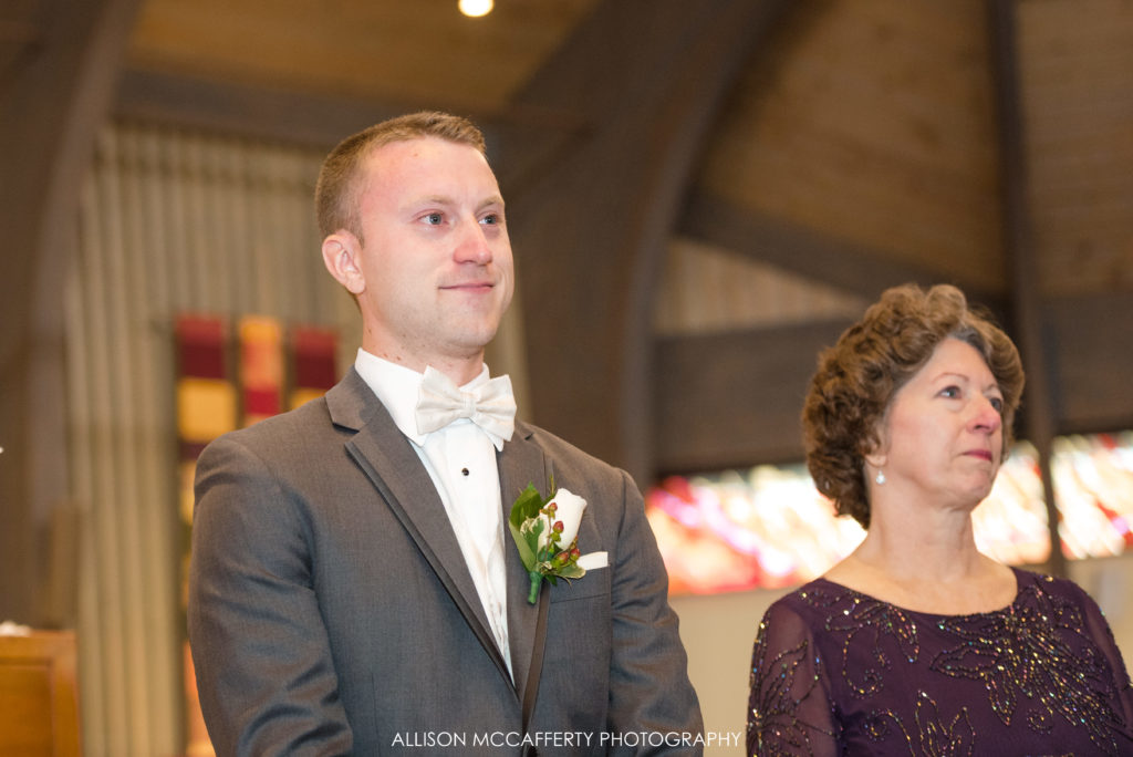 Groom seeing his bride walk down the aisle for the first time