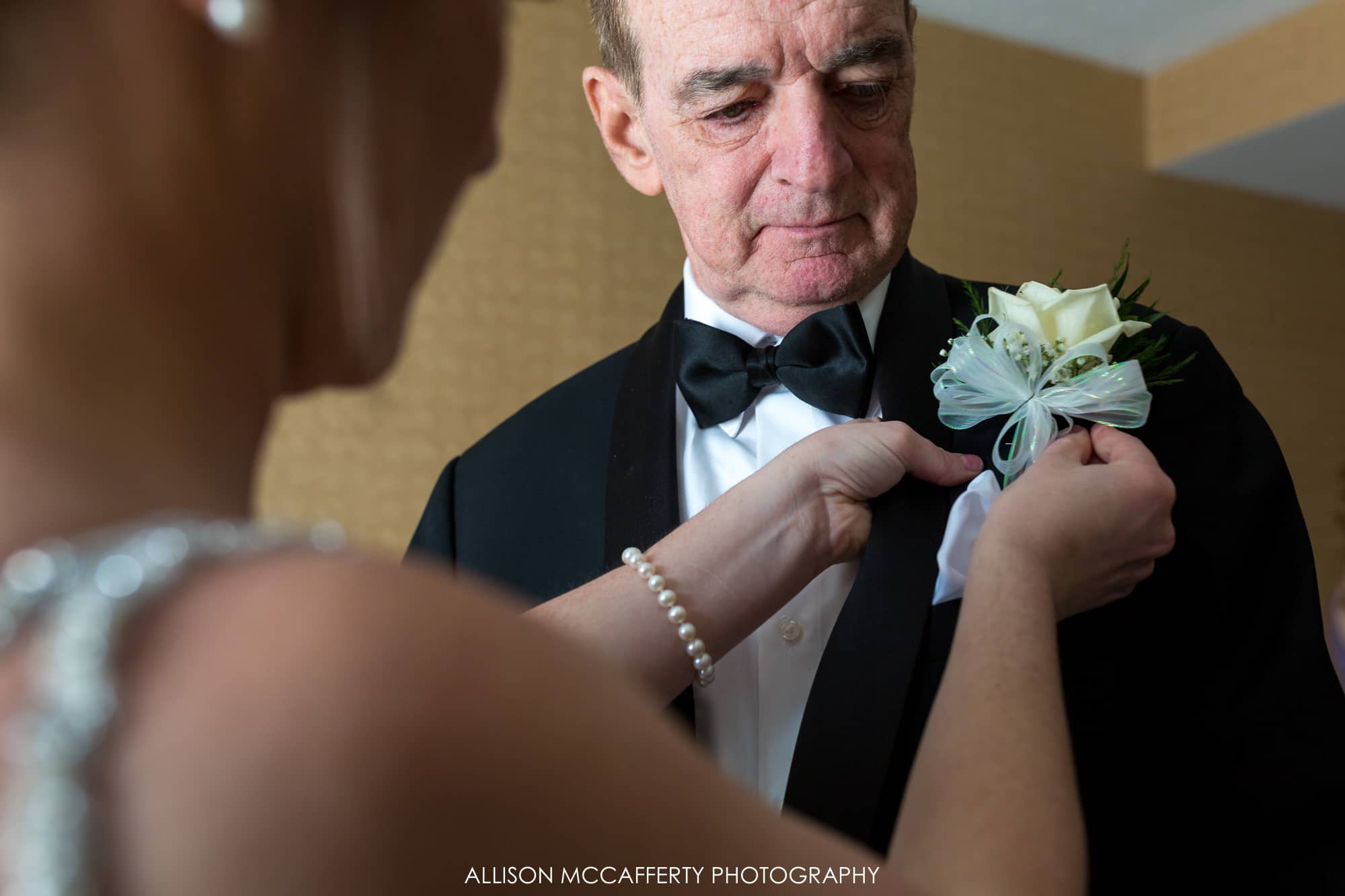 Bride giving her Dad a boutonniere 