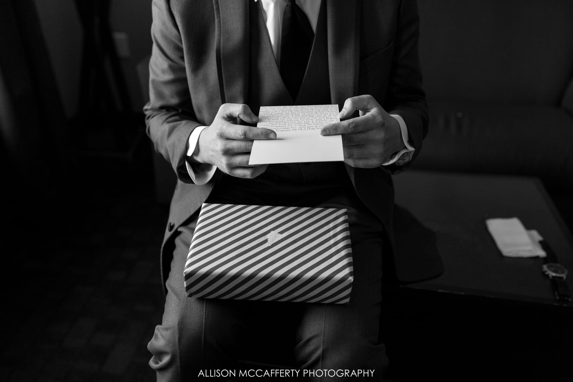 Groom opening a gift from his bride