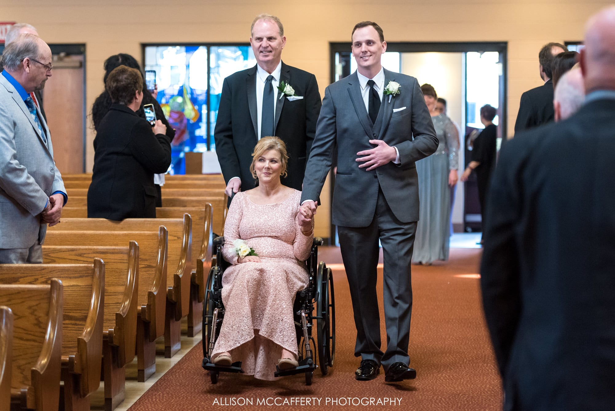 Groom and his Dad walking his Mom down the aisle for his wedding