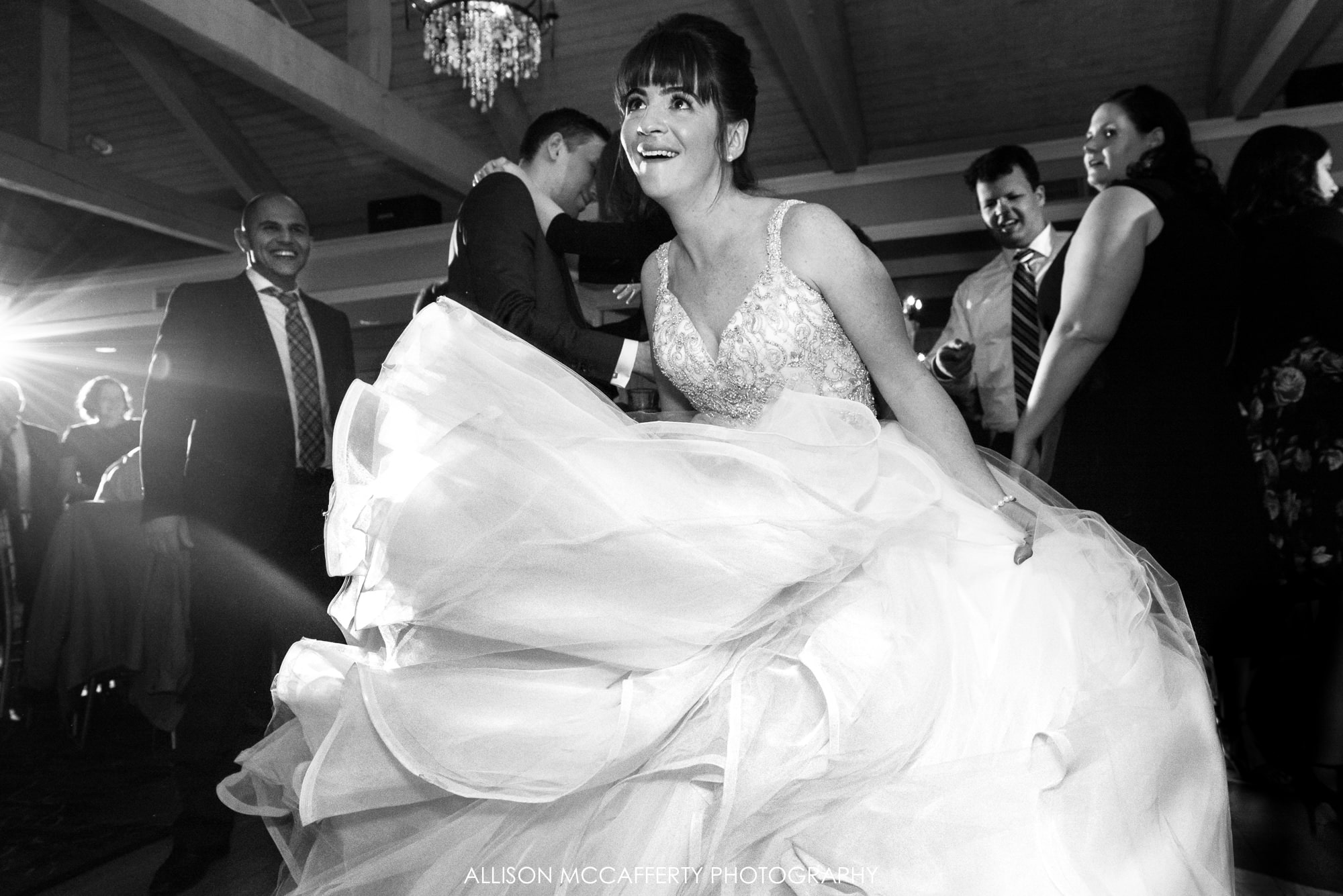 Black and white photo of bride dancing on the dance floor with a big dress Blue Heron Pines Wedding cost