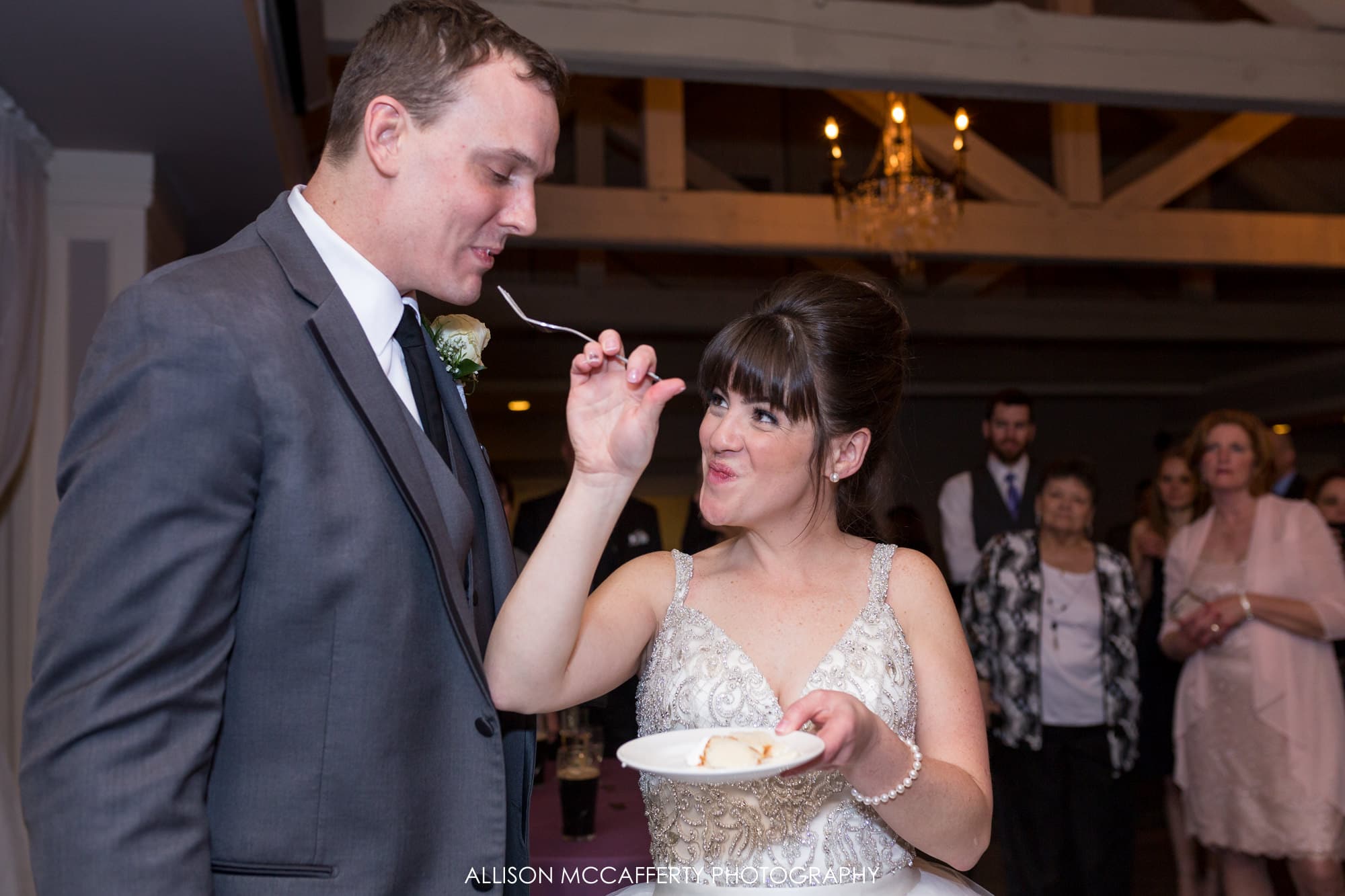 Bride feeding her husband cake during their wedding Blue Heron Pines Wedding Photos