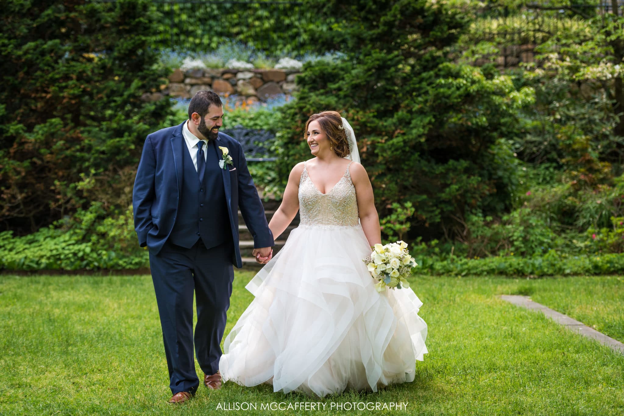 bride and groom walking in Reeves-Reed Arboretum