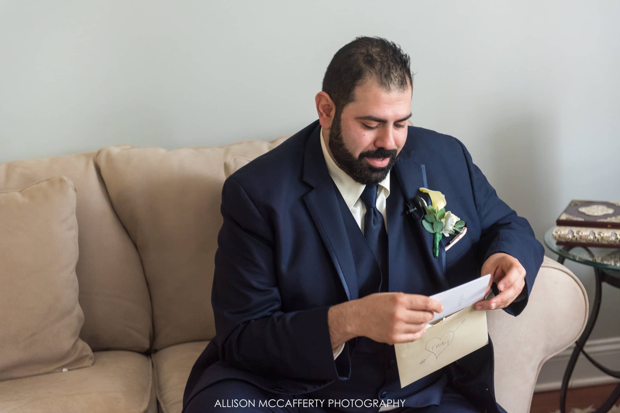 Groom reading a card from his bride to be