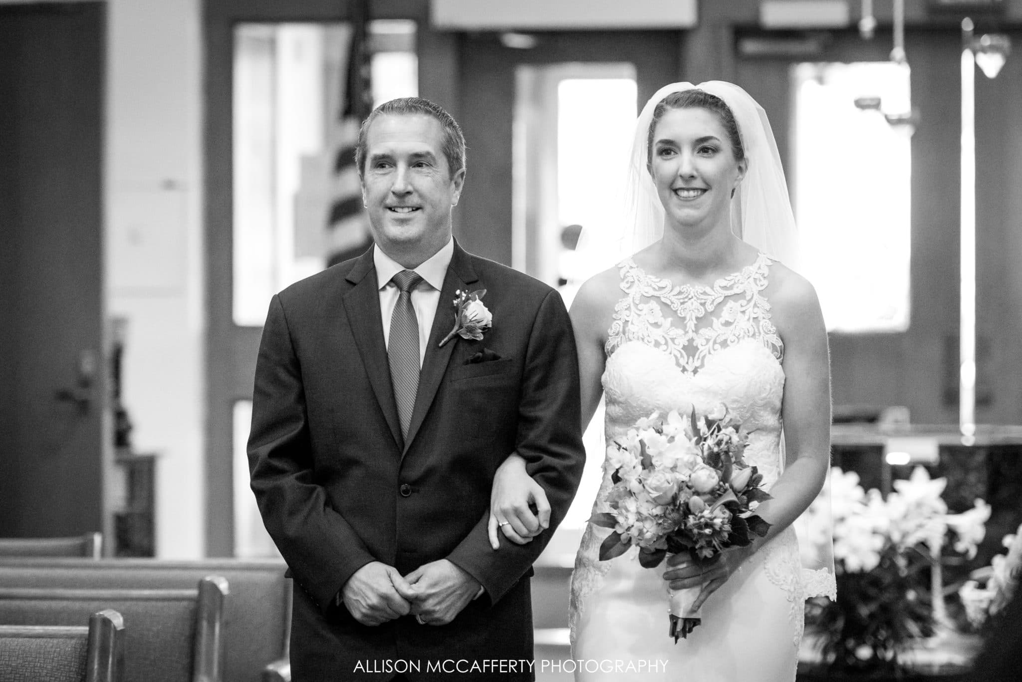Father and daughter walking down the aisle on her wedding day.