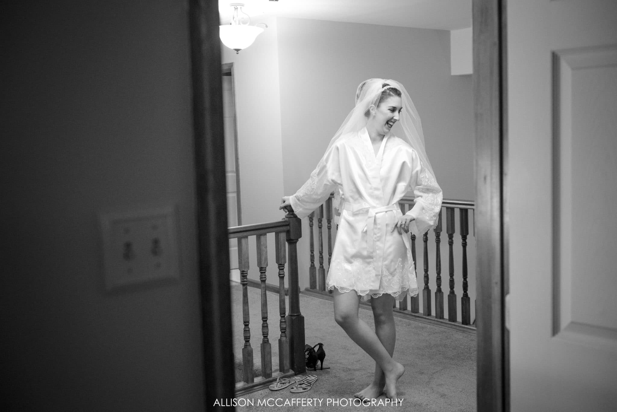 Black and white photo of bride waiting to get ready