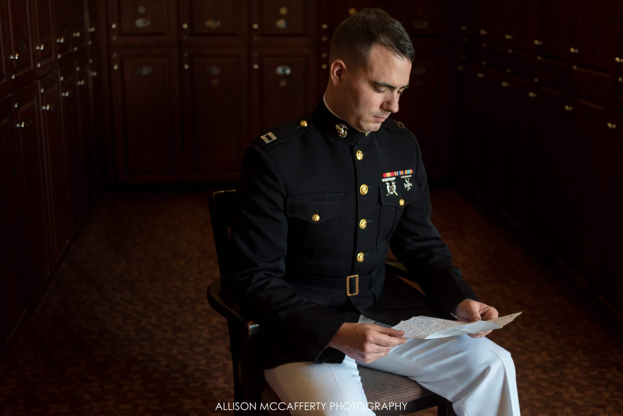 groom reading a letter from his bride in scotland run country club locker room