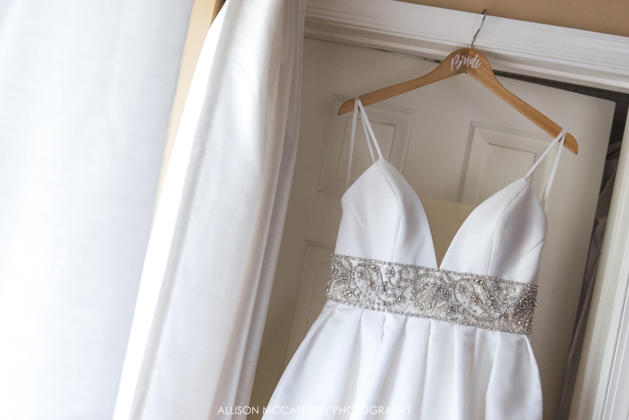 Wedding gown hanging by the window