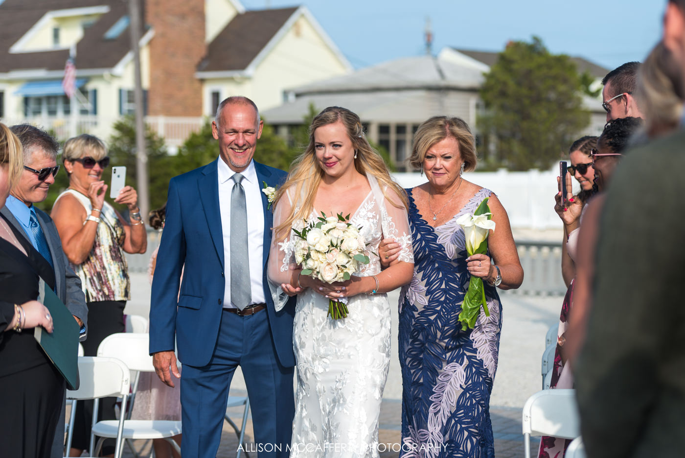 Parents walking their daughter down the aisle on her wedding day at Brant Beach Yacht Club 