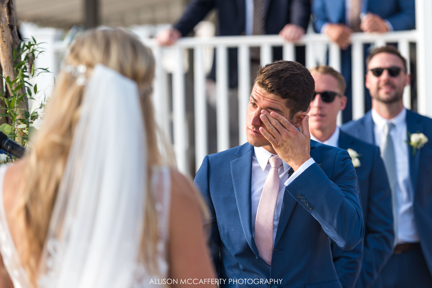 Groom crying during wedding ceremony at Brant Beach Yacht Club
