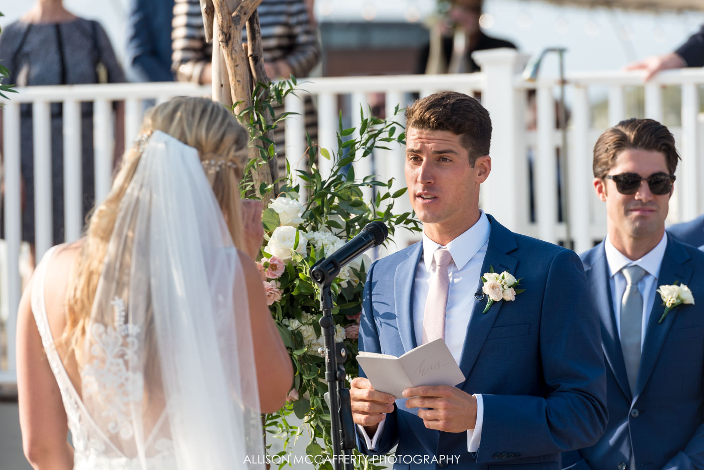 Groom reading his vows during an outdoor ceremony