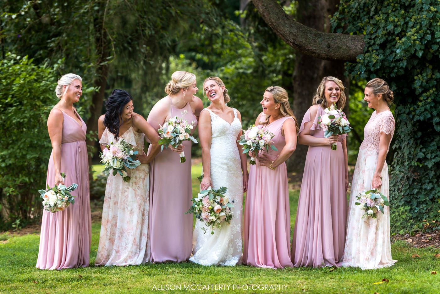 Bridesmaids dressed in pink and floral dresses at Rose Bank Winery