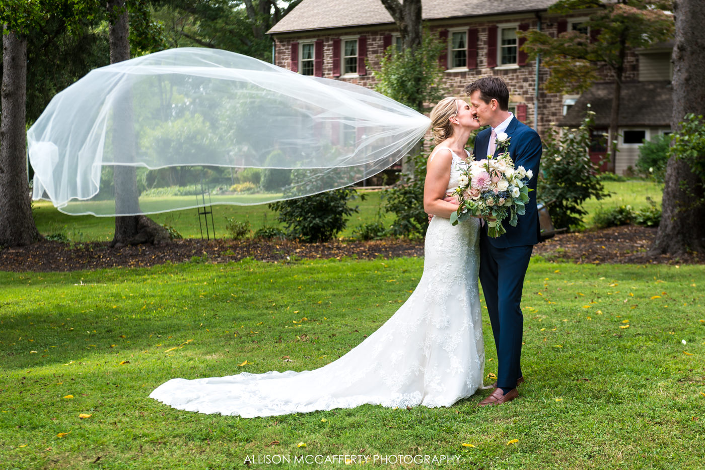Wedding photo of bride with long veil floating in air