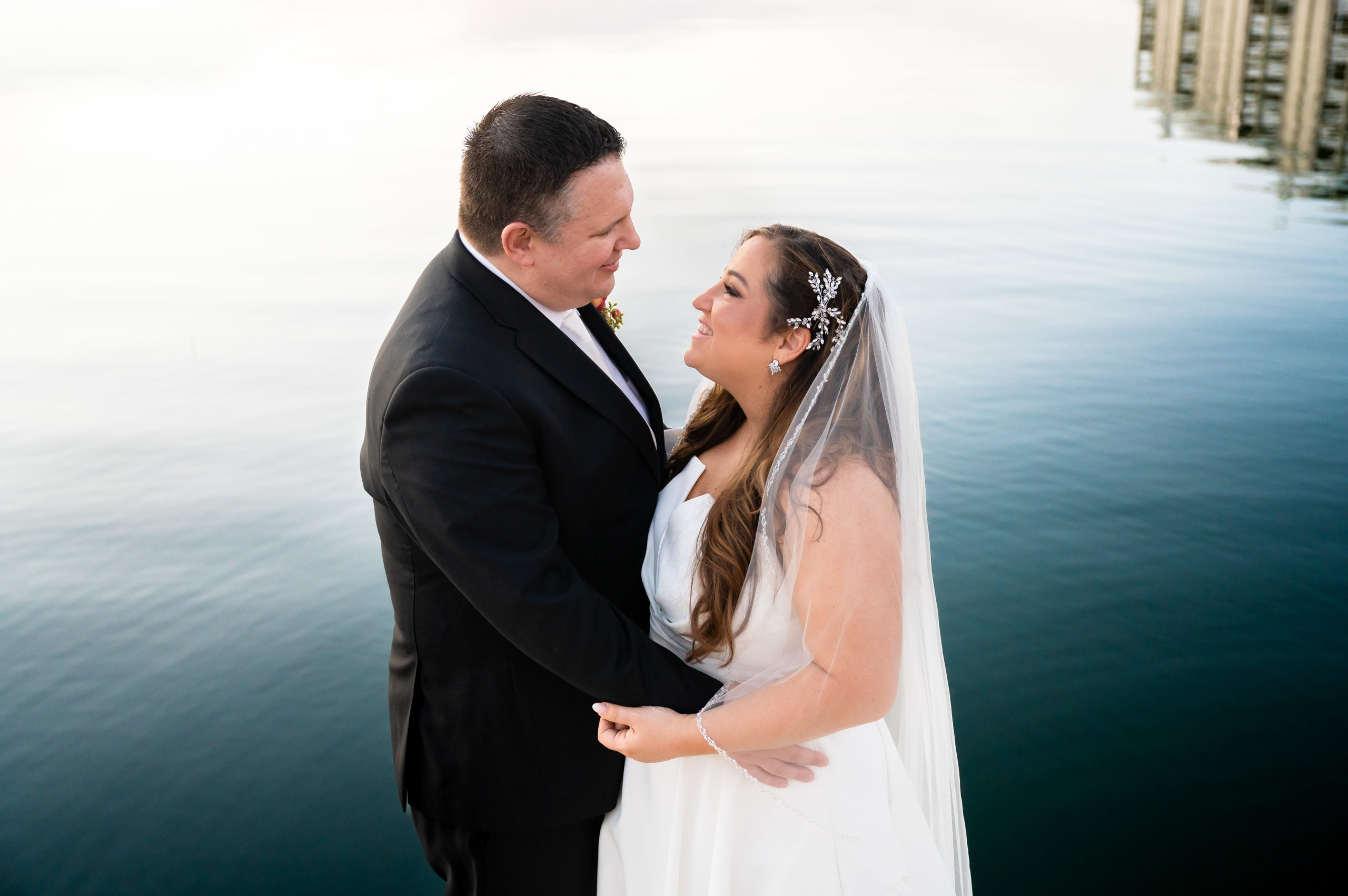 Wedding photo of a couple at the end of the dock behind the Reeds at Shelter Haven in NJ