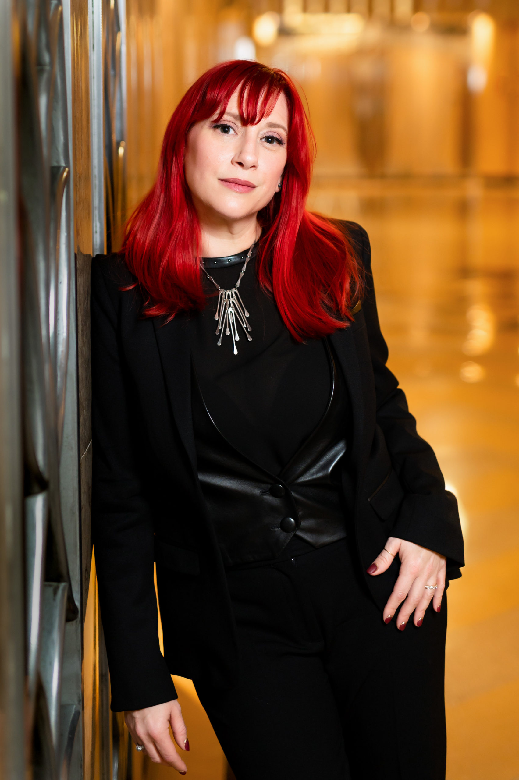 Manhattan headshot of a woman with red hair in the foyer of her office building