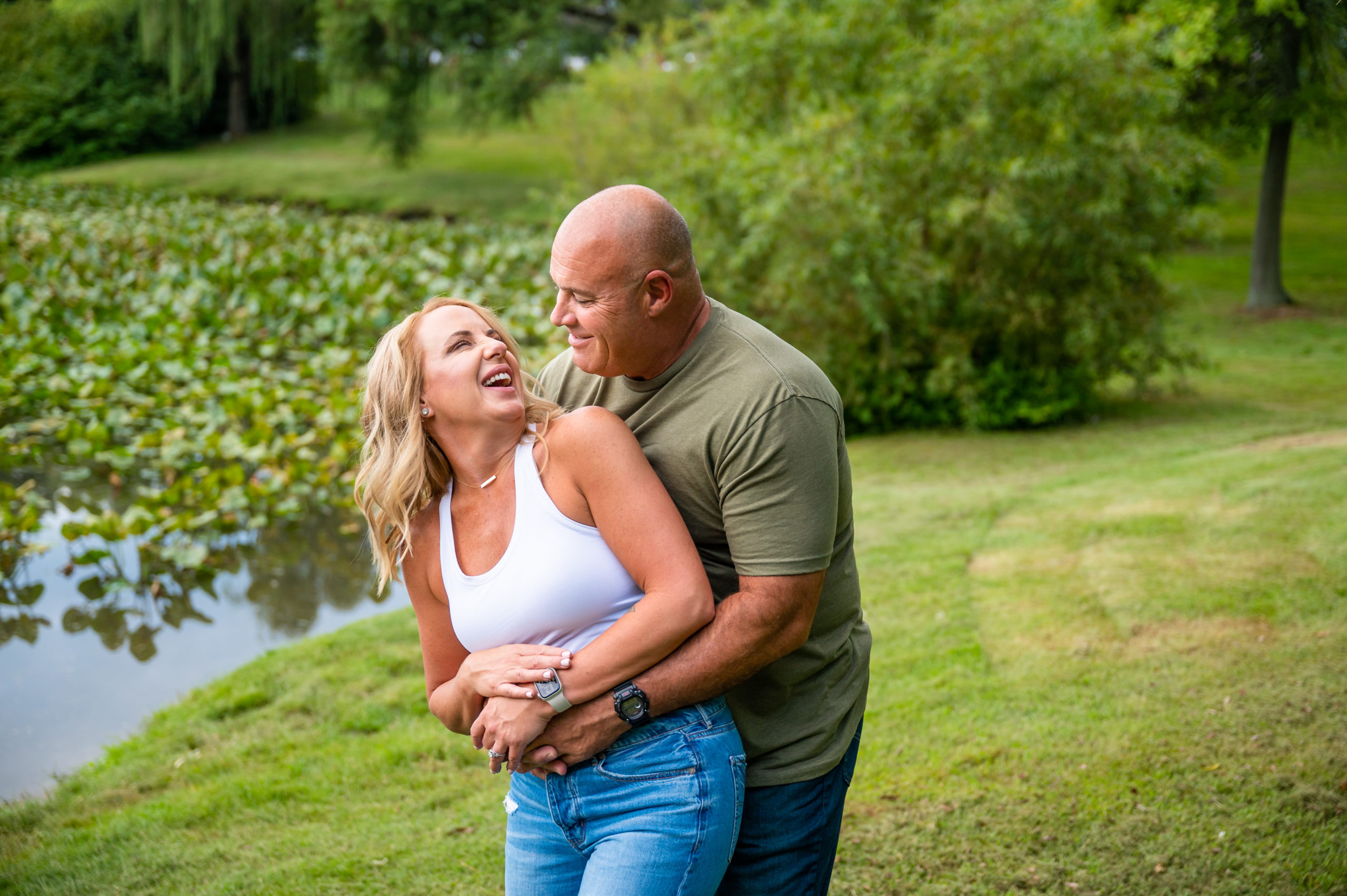 Engagement photo of a couple outside by lily pads in South Jersey
