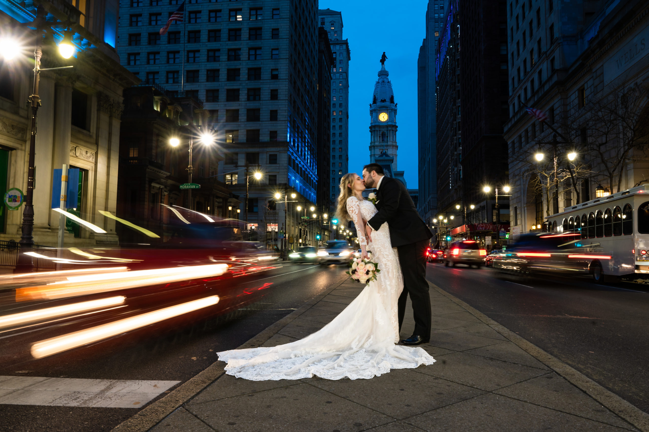Wedding photo on broad street in Philadelphia at night with shutter drag