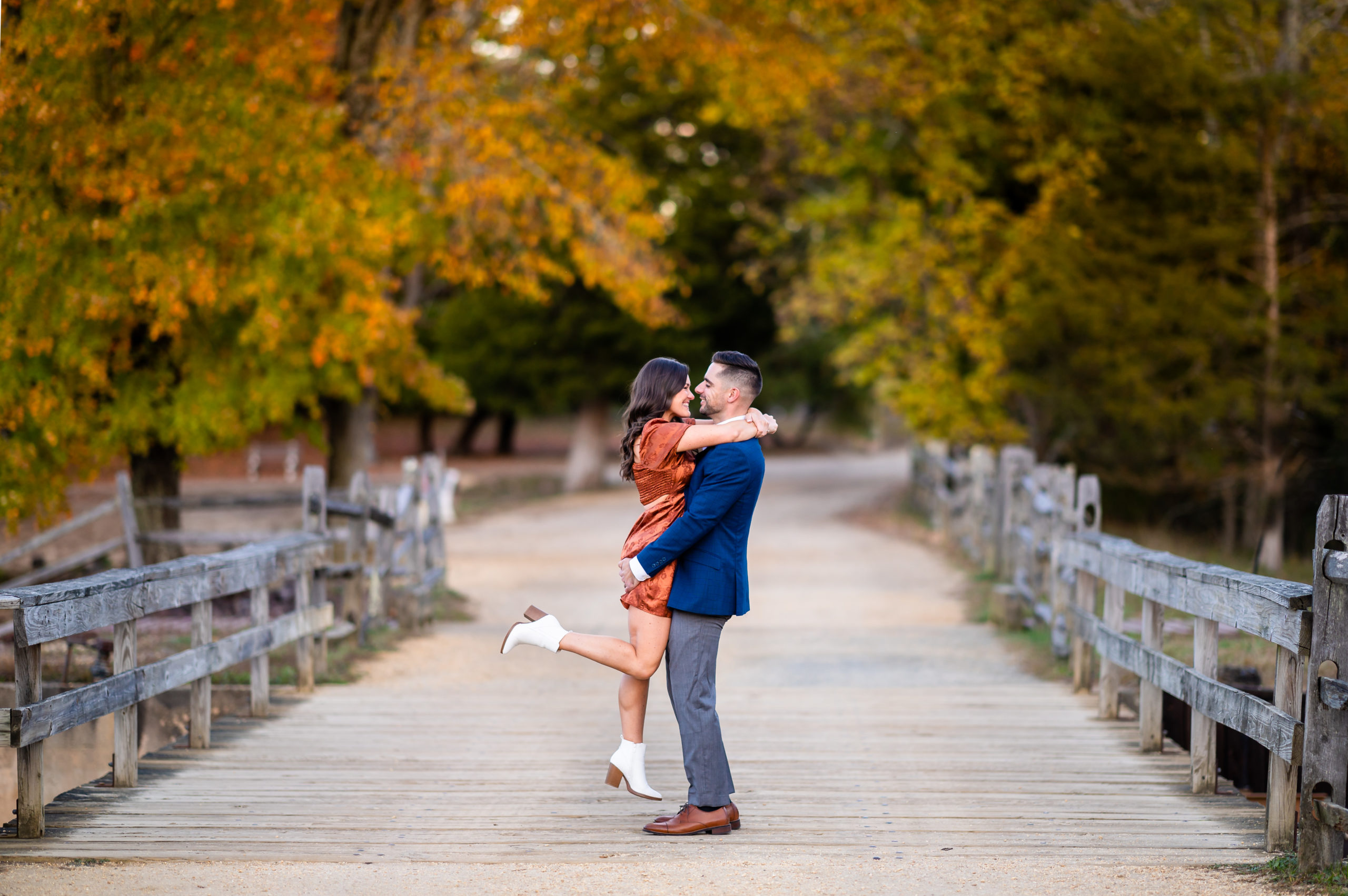Colorful Fall engagement photo of a couple at Batsto Village in Hammonton NJ