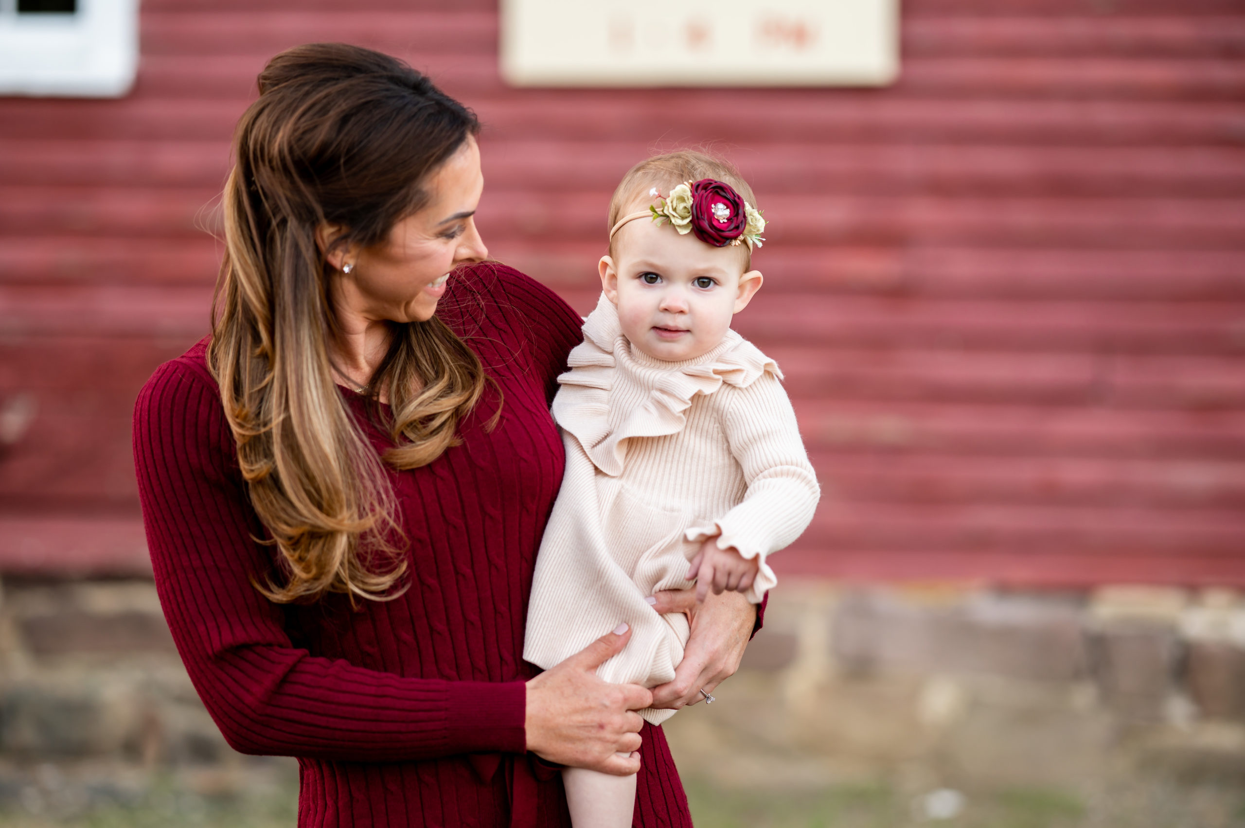 Family photo of a mother and daughter wearing read in front of Kirby's Mill in Medford NJ