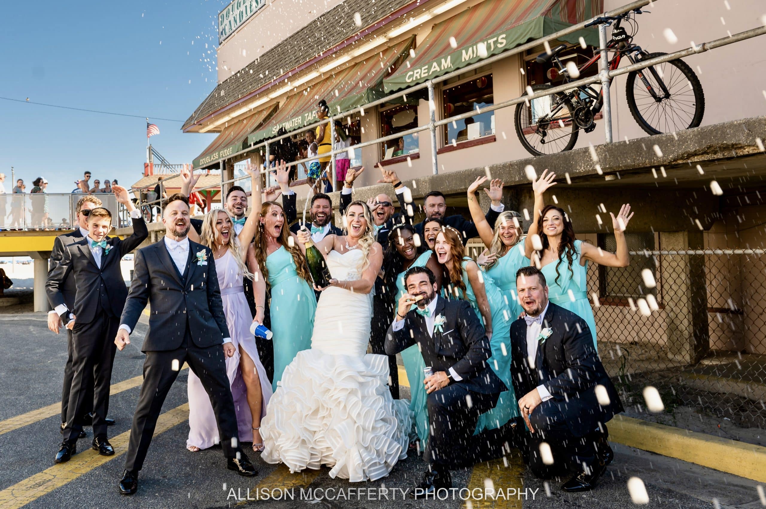 Champagne spray photo of a wedding party off the boardwalk in Wildwood NJ