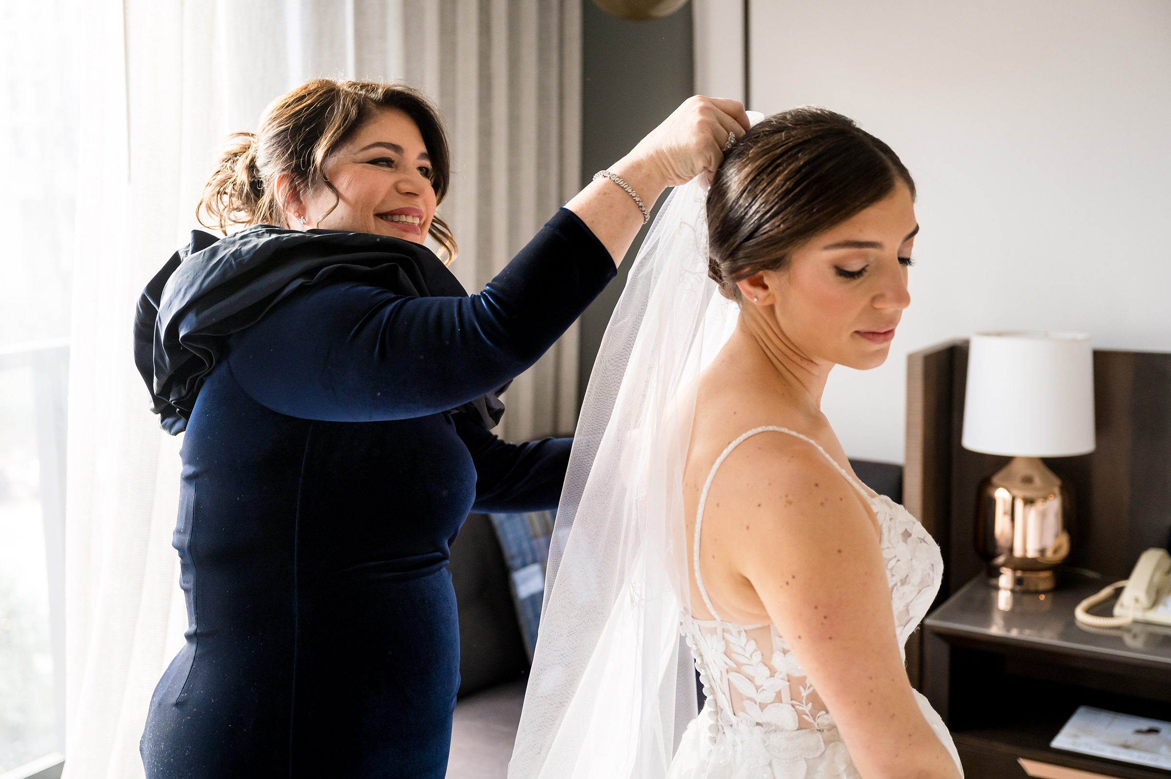 A bride preparing for her Lilah Events wedding in a hotel room.