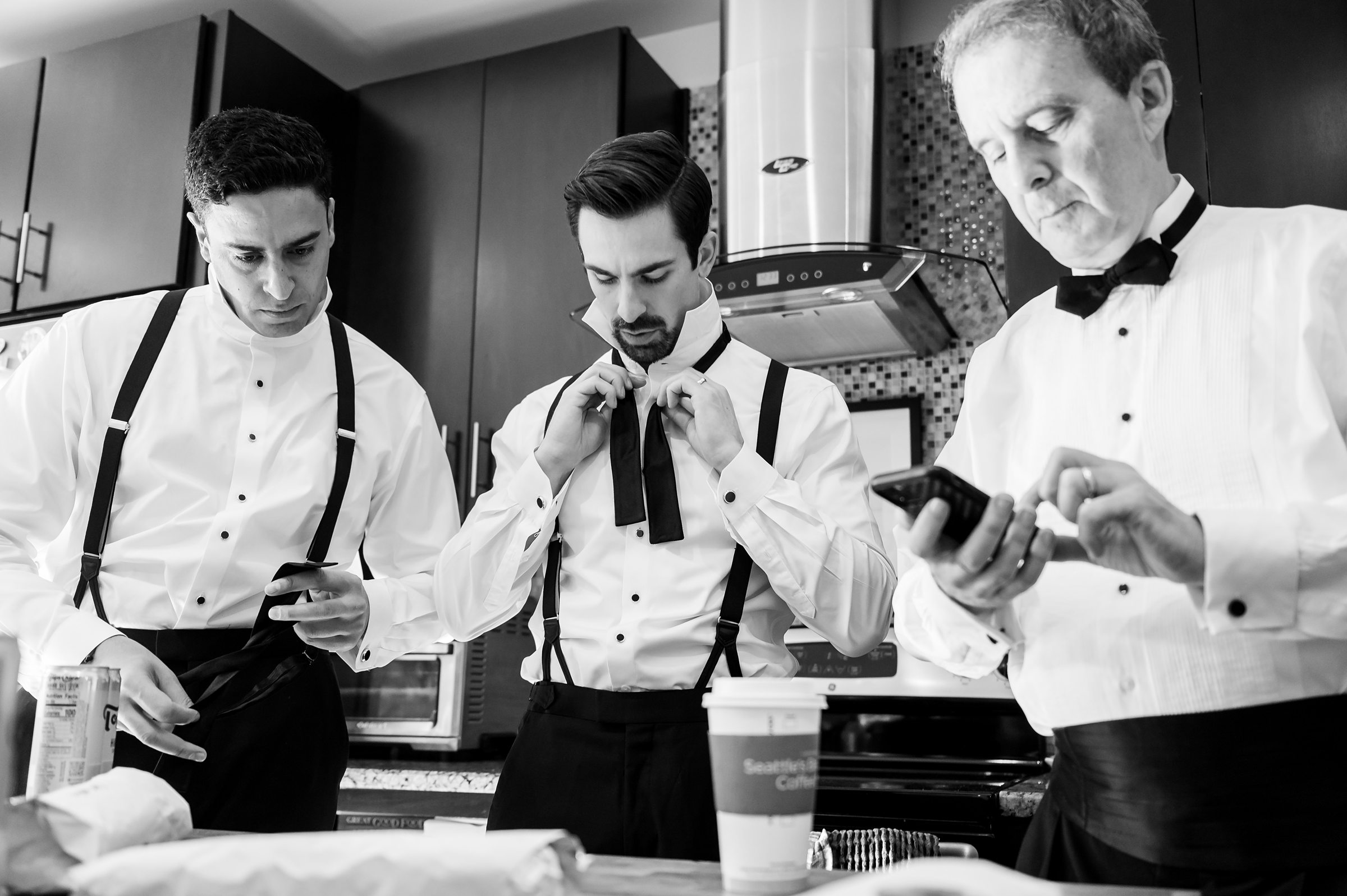 Three men in tuxedos getting ready for a Lilah Events wedding.