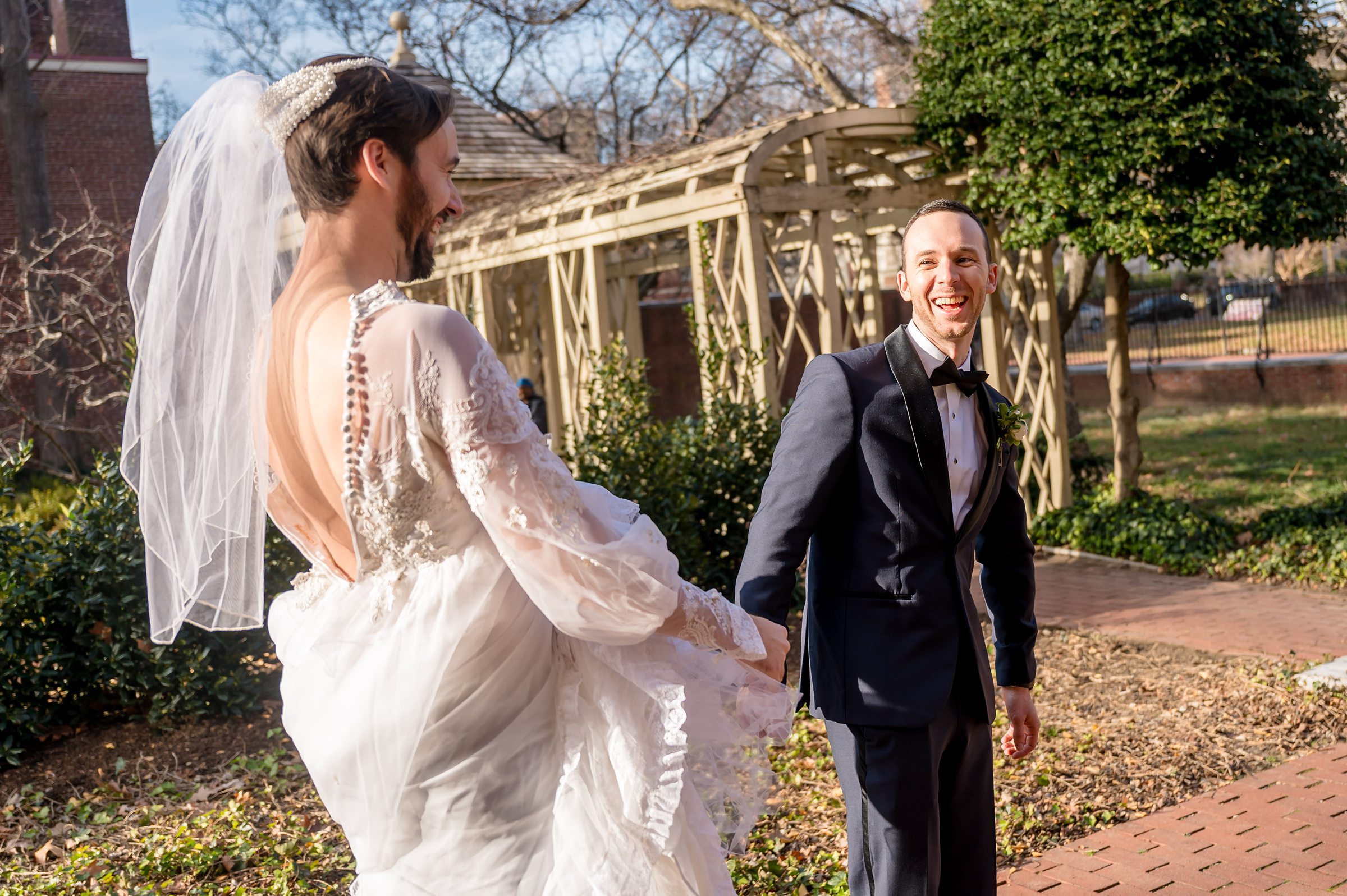 A bride and groom strolling down a brick walkway during their Lilah Events wedding.
