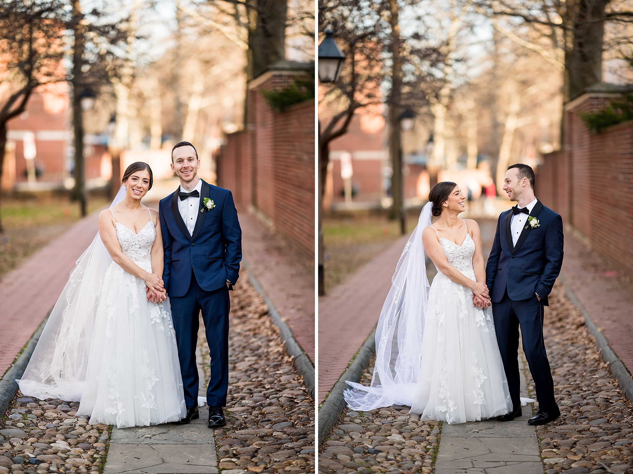 A bride and groom pose for a wedding photo on a cobblestone street.