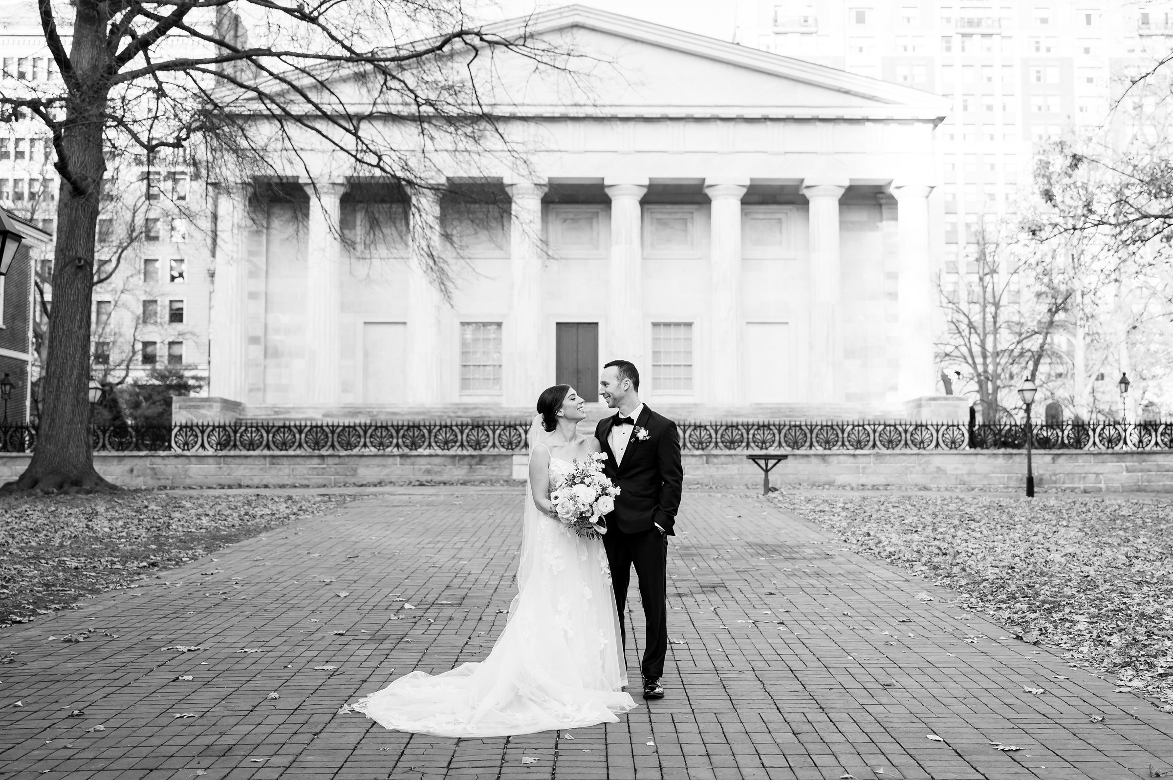 A bride and groom standing in front of a building, captured by Lilah Events.