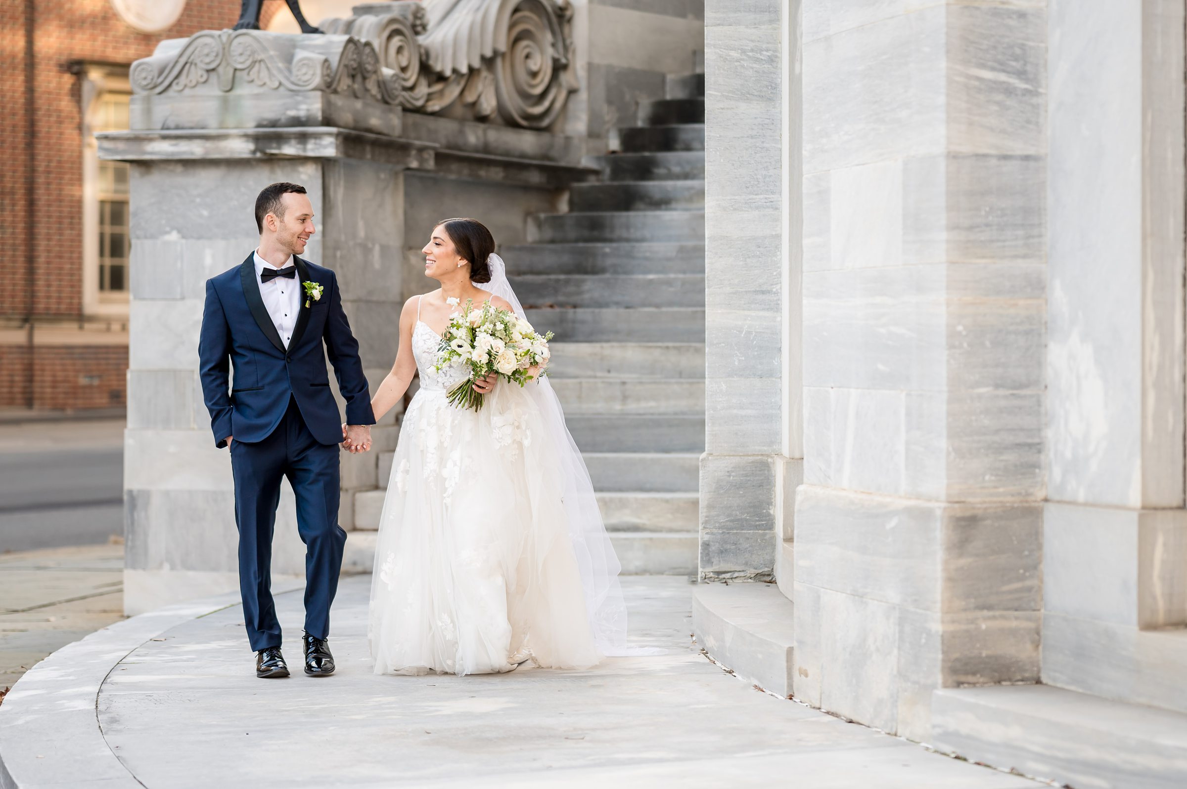 Lilah Events Wedding: A bride and groom descend the steps of a building.