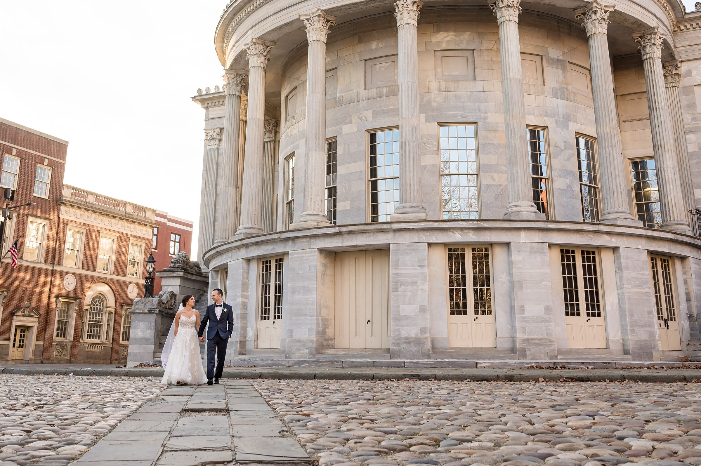 Lilah Events Wedding: A bride and groom standing in front of an old building.