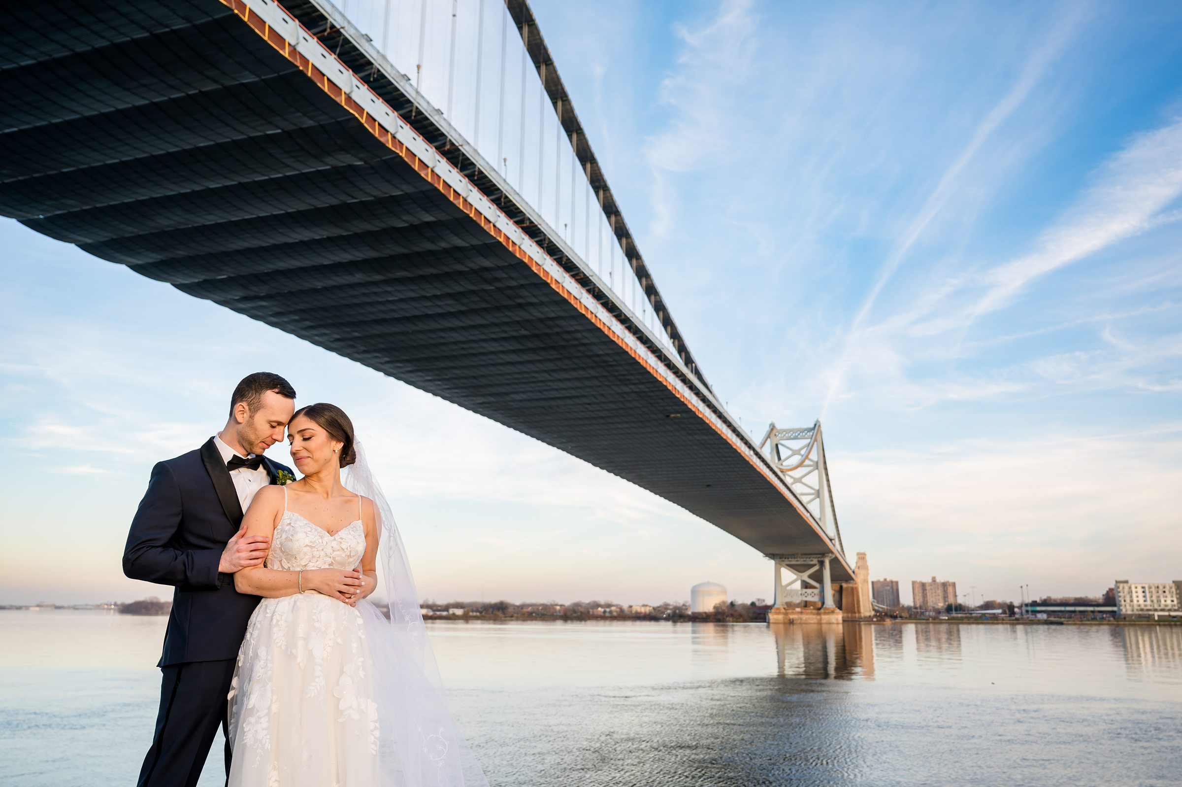 A bride and groom posing under a bridge in Philadelphia for their Lilah Events wedding.