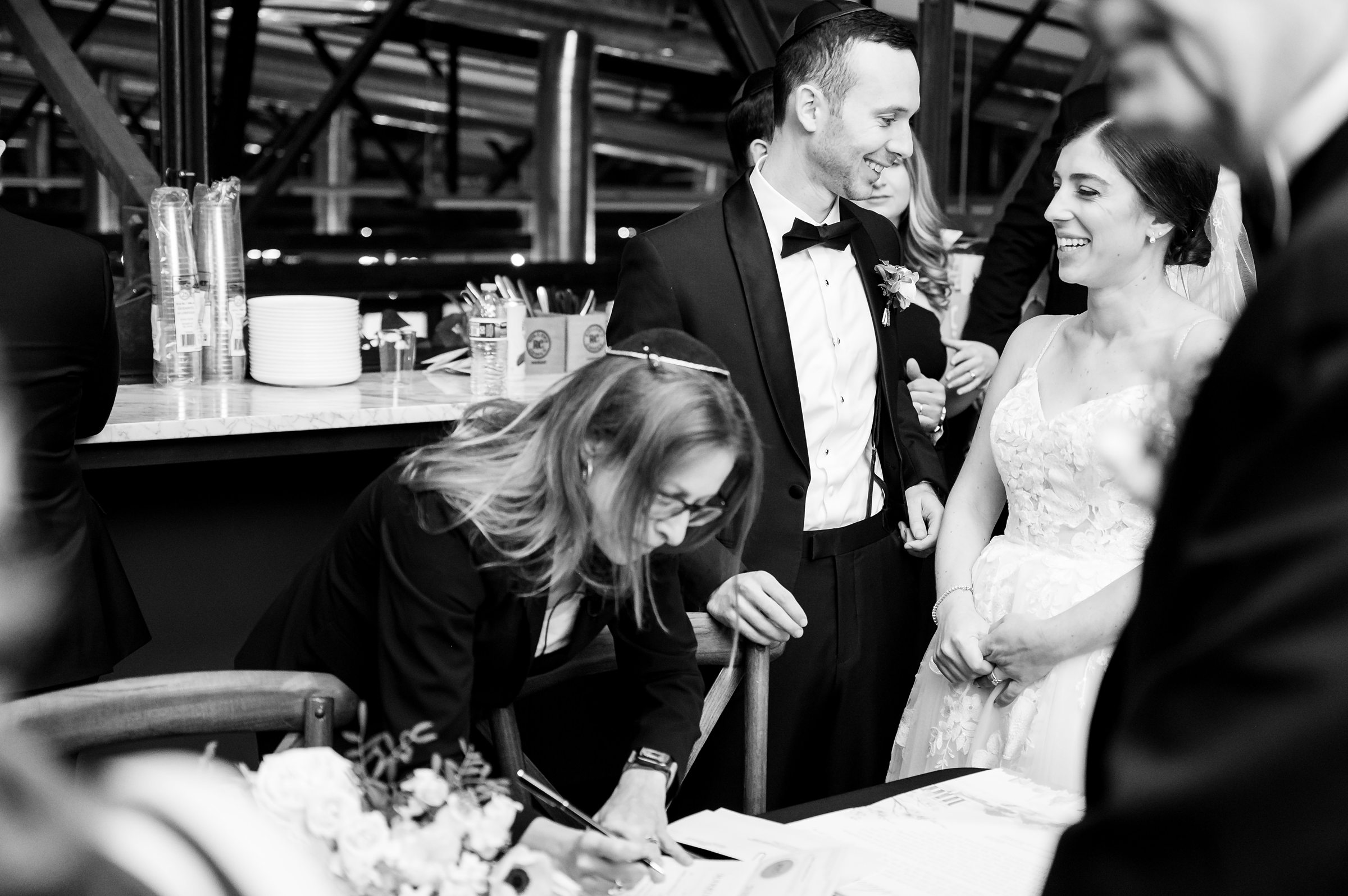 A bride and groom signing their wedding vows at a Lilah Events wedding.