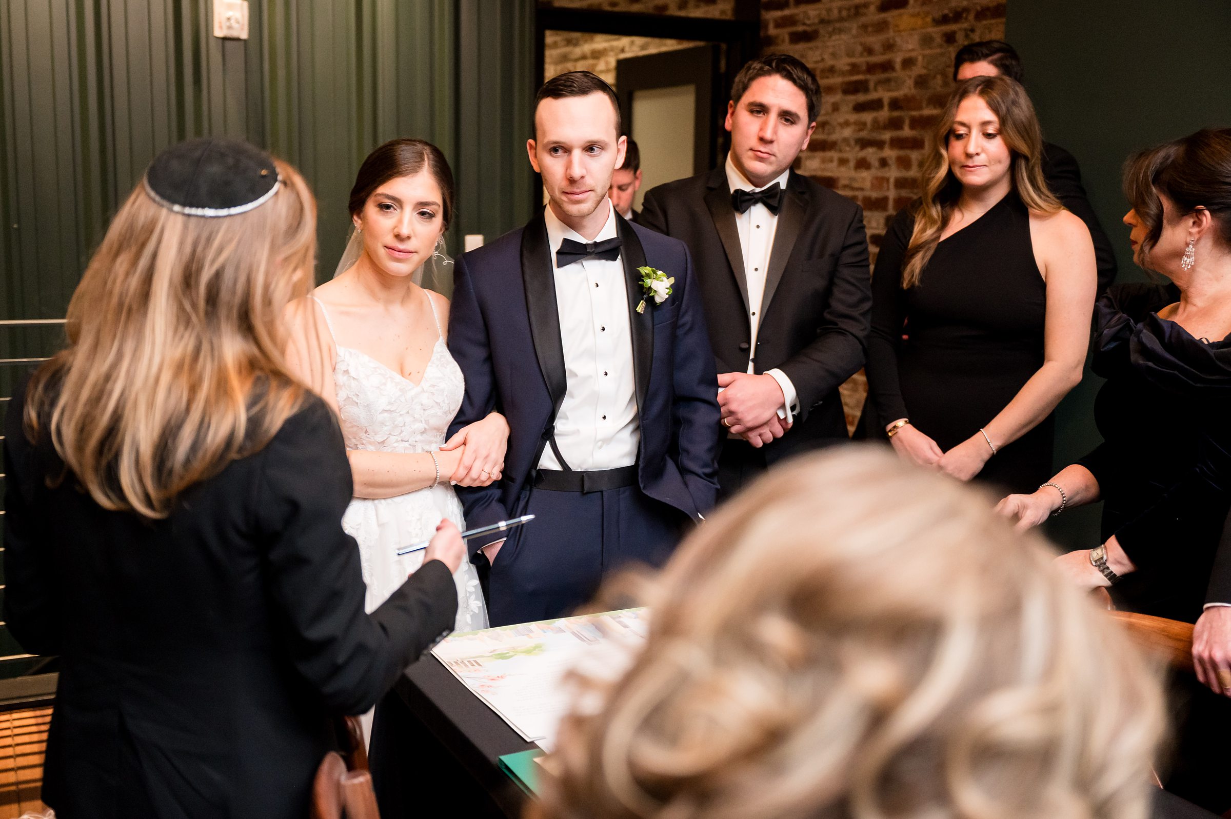 At a Lilah Events wedding, a group of people is gathered around a table.