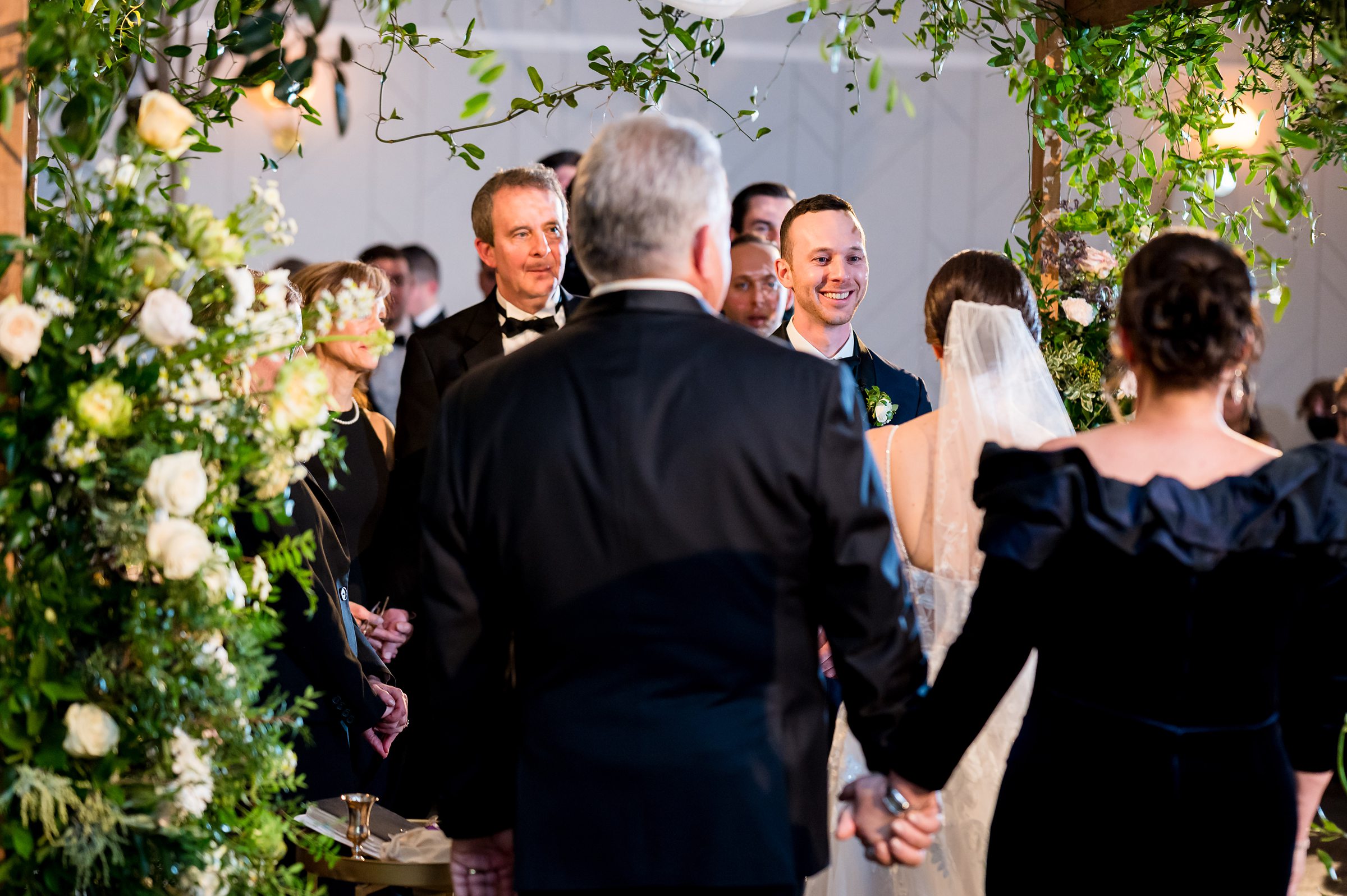 At a Lilah Events wedding, the bride and groom stroll down the aisle.