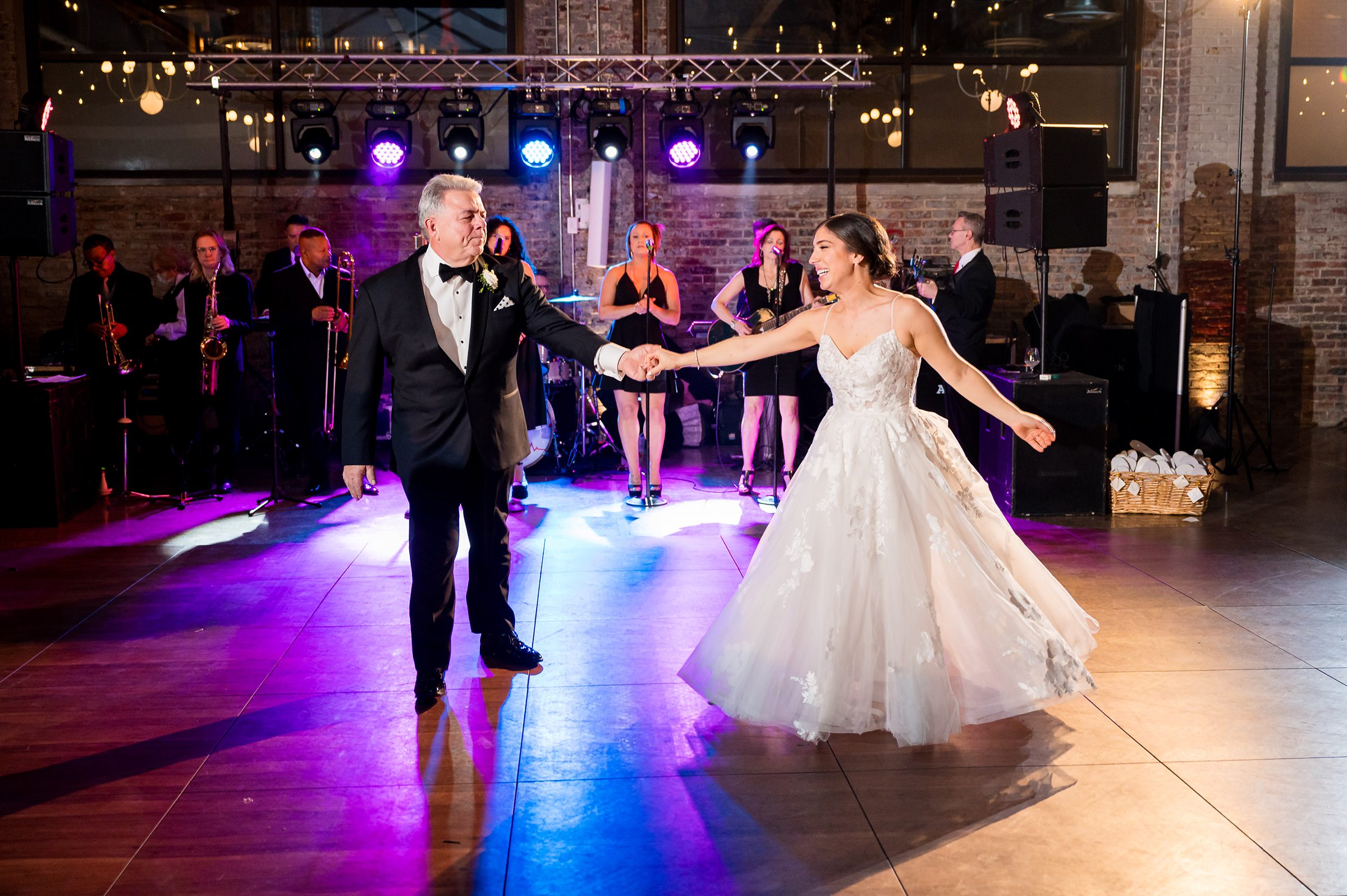At a Lilah wedding event, the bride and groom are gracefully dancing at their reception.