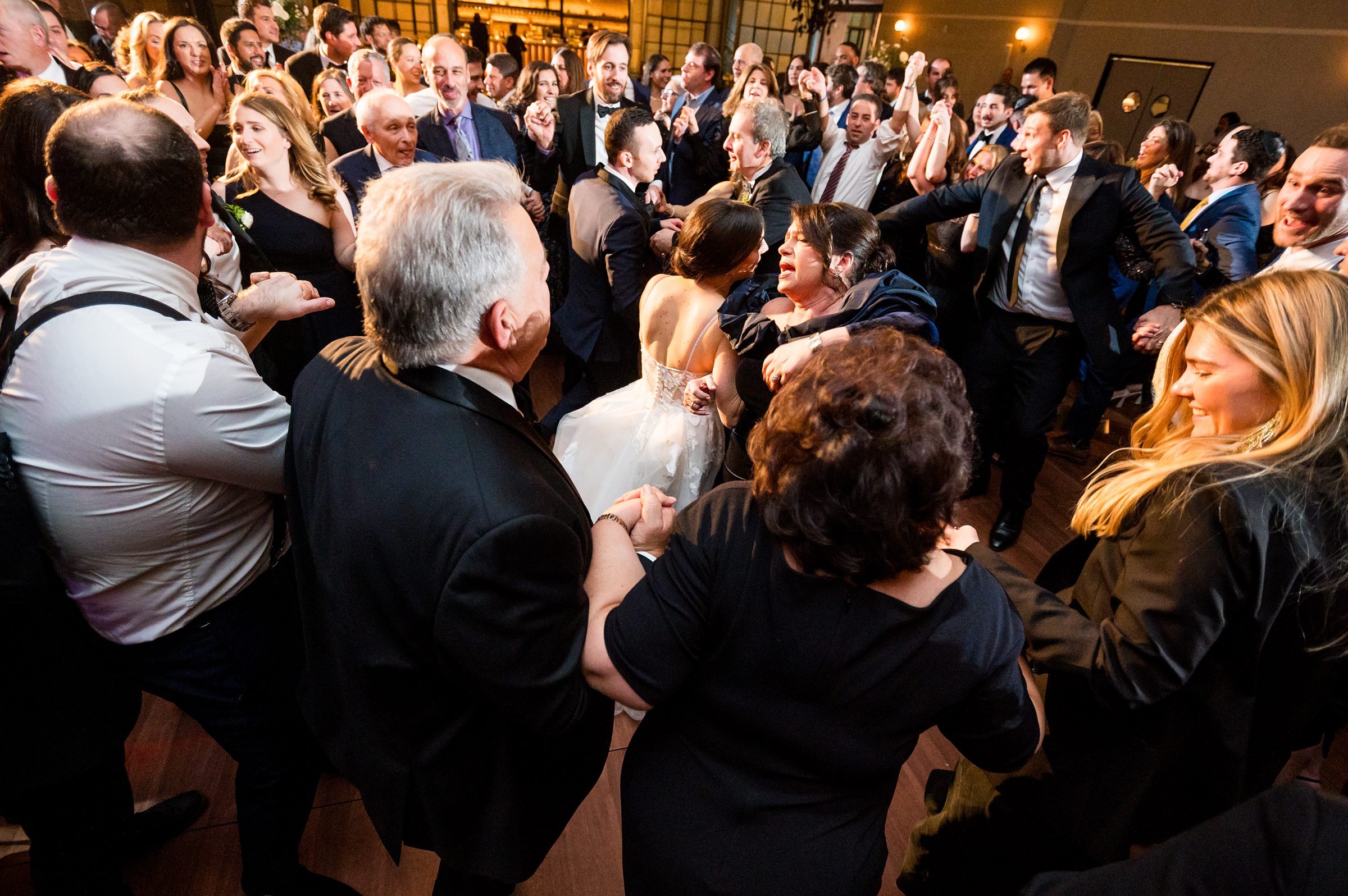 Attendees at a Lilah Events wedding reception dance joyfully.