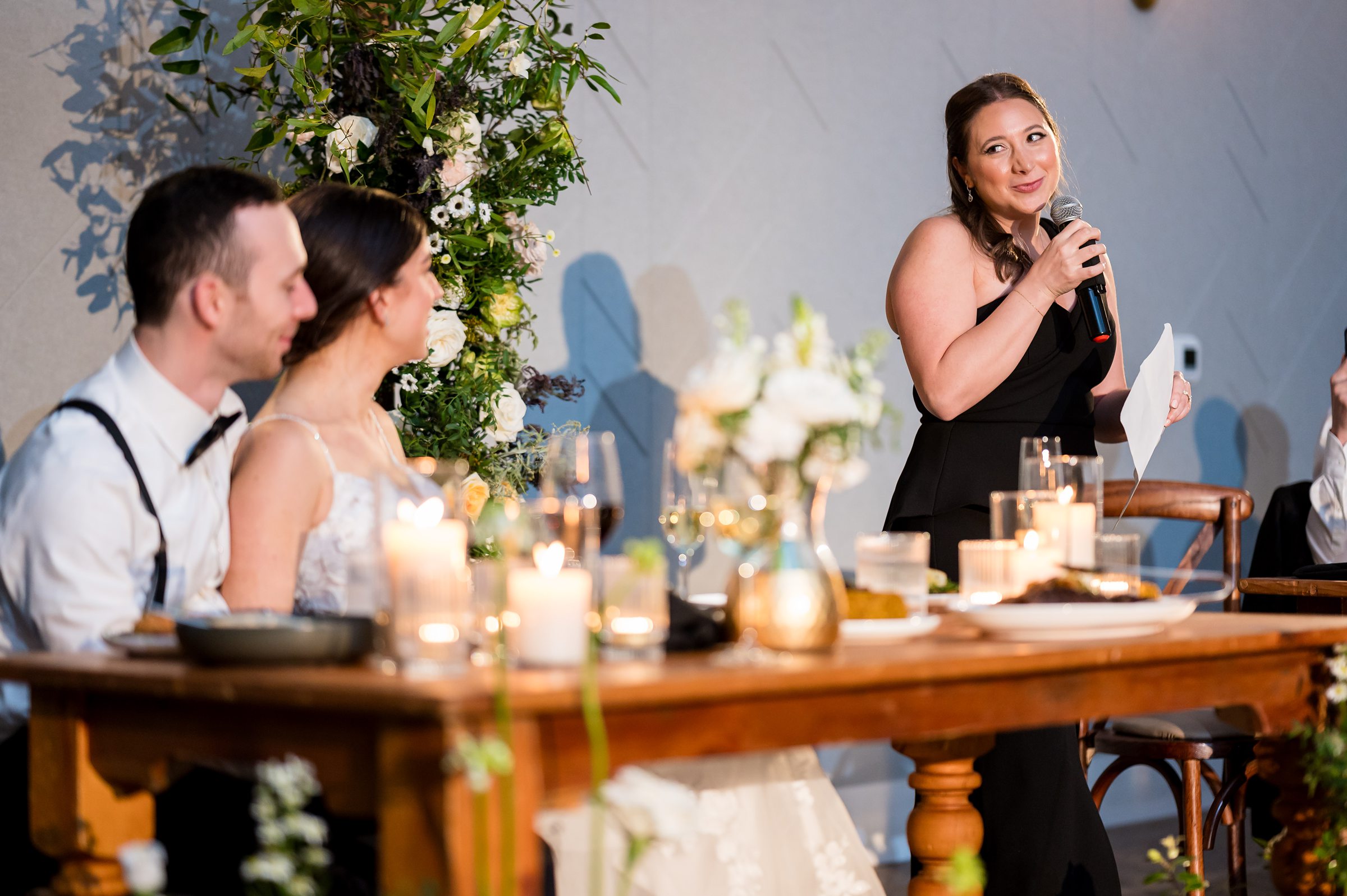 A bride giving a speech at her Lilah wedding reception.