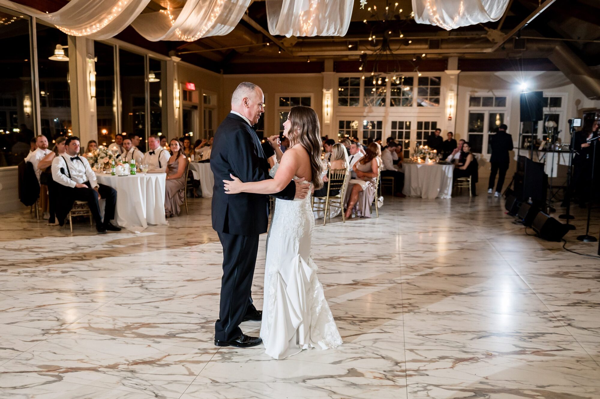 A bride and groom sharing their first dance at their wedding reception.