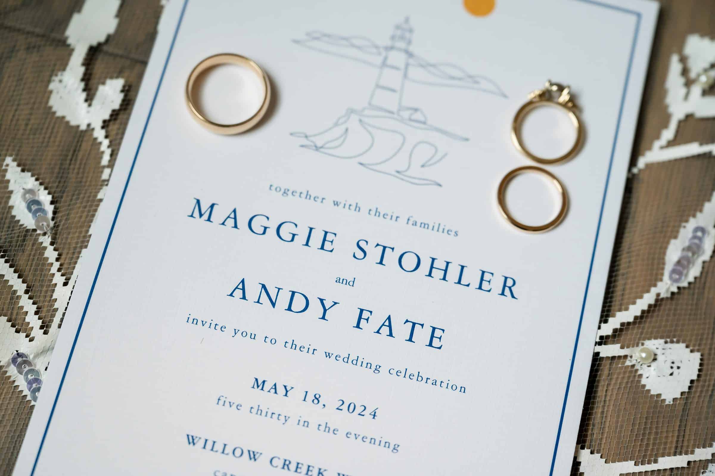 A wedding invitation for Maggie Stohler and Andy Fate's ceremony on May 18, 2024, at 5:30 PM, featuring two gold wedding bands and an engagement ring.