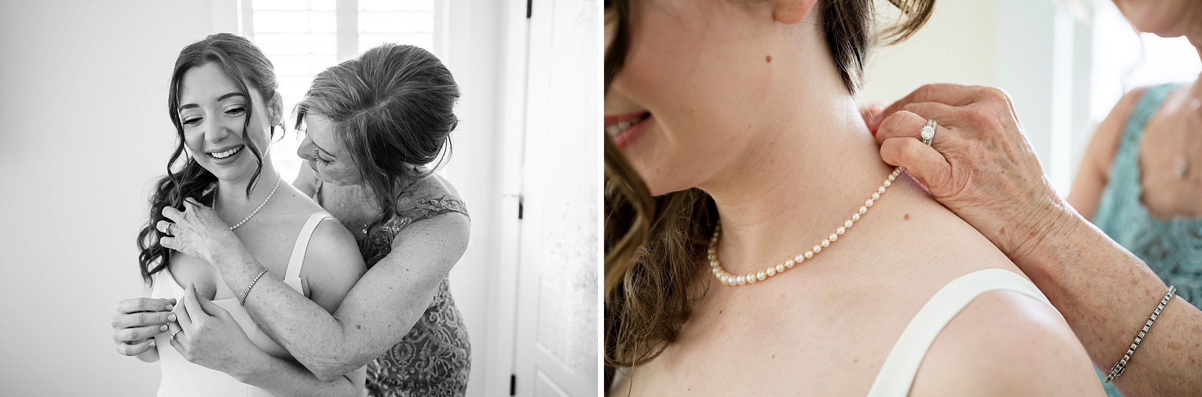A woman helps a bride put on a pearl necklace in a softly-lit room. Close-up shows hands fastening the necklace. Bride smiles, feeling the necklace being secured.